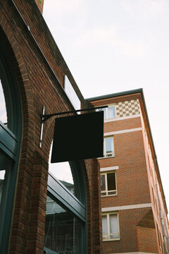 Black Sign on Brick Building