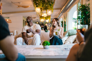 Friends enjoying drinks and conversation at a cafÃ©