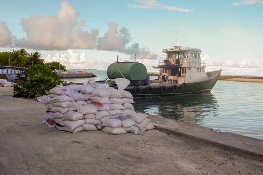Docked Boat with Stacked Sandbags