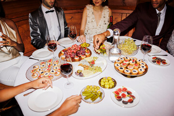 Elegant friends enjoying gourmet appetizers at new year's eve ugc