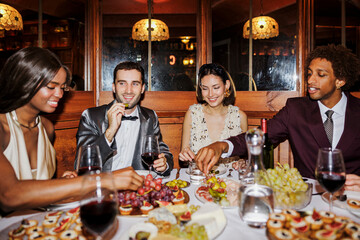 Elegant friends enjoying dinner party at new year's eve ugc