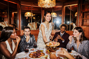 Elegant friends enjoying dinner party in luxurious restaurant ugc