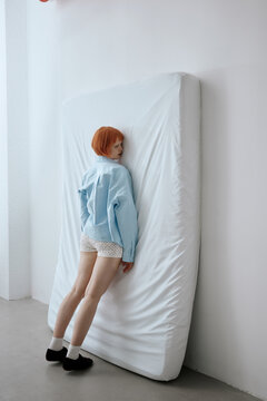 Tired woman lying on mattress