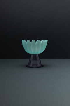 Translucent bowl with floral design on a minimalist dark background