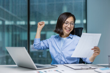 Successful Asian financier investor celebrating victory and triumph. Well done businesswoman...