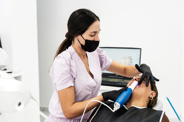 Dentist scanning patient teeth
