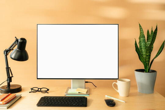 A computer with white screen on the table