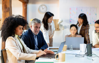 Work colleagues working on project in office