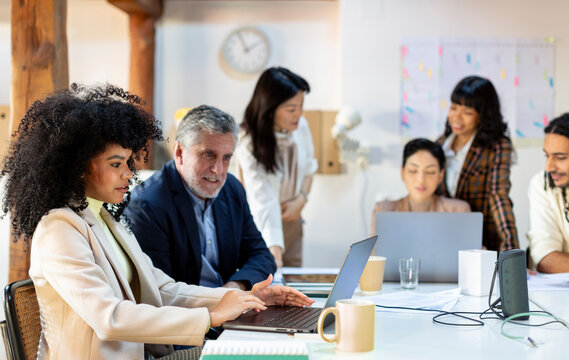 Work colleagues working on project in office