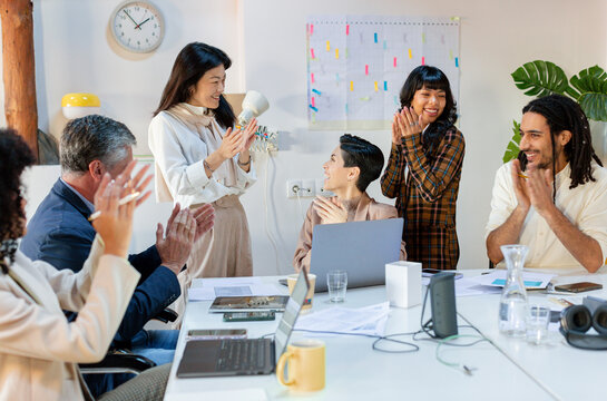 Diverse Business team in work meeting celebrating team achievement 