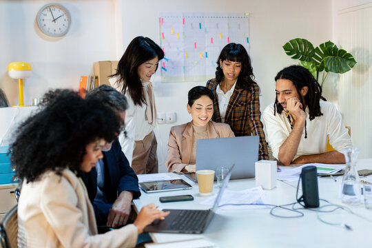 Diverse Business team working on project around table