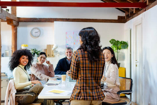 group of coworkers in business meeting talking to project leader
