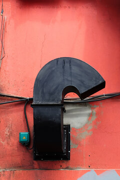 Black Vent on Red Wall