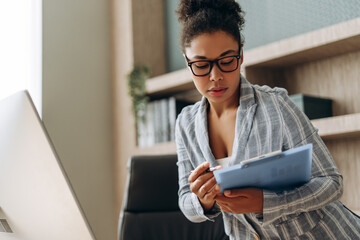 Focused businesswoman working with documents in modern office