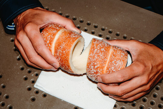 man is about to split a Hungarian chimney cake