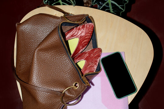 Open female bag with shoes in it