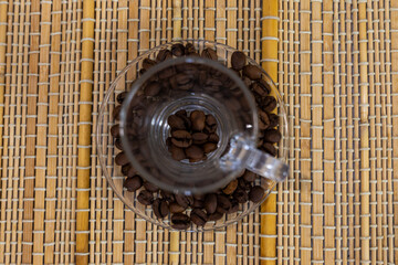 coffee and coffee beans on a straw tablecloth during an afternoon or morning coffee with beans arranged around