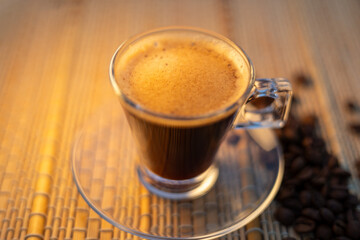 coffee and coffee beans on a straw tablecloth during an afternoon or morning coffee with beans arranged around