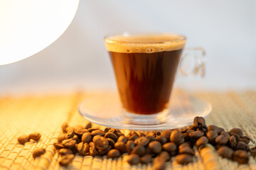 coffee and coffee beans on a straw tablecloth during an afternoon or morning coffee with beans arranged around