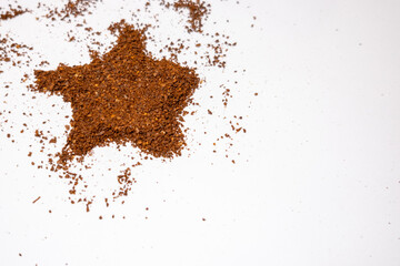 star made of coffee powder on white background