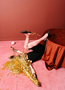 Woman in Elegant Black Dress Falls Over During Party Celebration