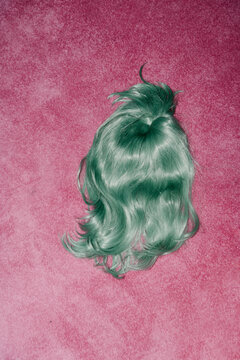 Vibrant Green Wig on Pink Carpet Creating Bold Contrast