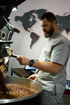 Coffee roaster carefully monitoring the roasting process in a caf&eacute; 