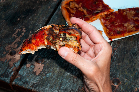 man eating a piece of spanish coca de verduras