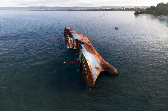 Aerial view of a  partially submerged rusted shipwreck in west java
