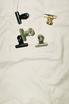 Close-up of formal trousers and paper clips on the pocket with flash