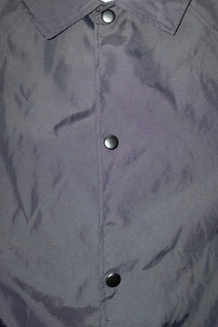 Close-up of classic black jacket with collar and buttons with flash