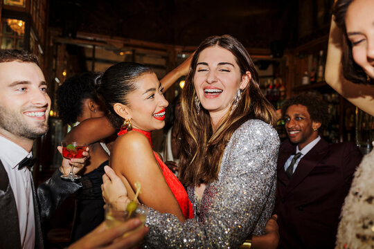 Cheerful friends hugging, celebrating new year's eve at disco ugc