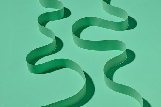 Abstract Green Paper Curves on a Minimalist Background