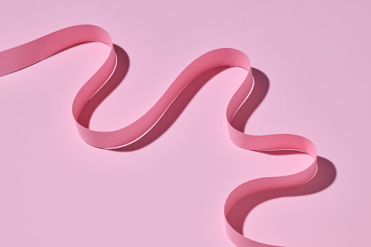 Elegant Pink Ribbon Curves on Pastel Background