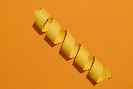 Yellow Paper Curl on Orange Background Abstract Art - Powered by Adobe