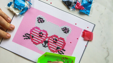 diamond mosaic painting in progress, hobby for kids and adults