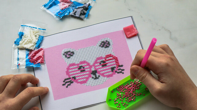 diamond mosaic painting in progress, hobby for kids and adults