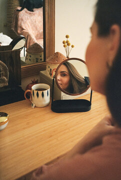 A pregnant woman sitting and combing her hair