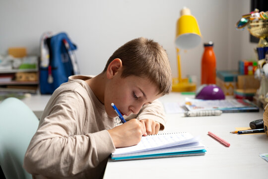 kid doing homework in his room
