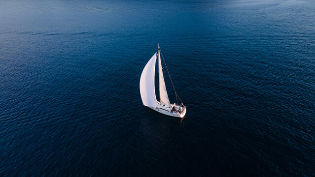 Soolitary White Sailboat on Calm Blue Sea