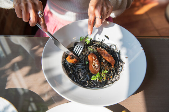 Fried calamari and salmon roe on squid ink pasta