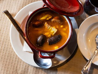 Popular delicious dish of Spanish cuisine is Fabada soup, made from white beans with smoked pork...