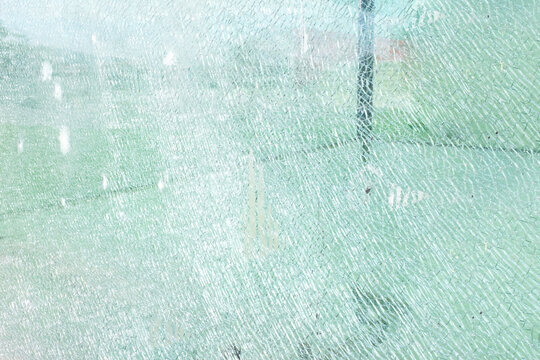 Close-up of a broken turquoise fracture glass texture pattern