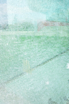 Close-up of a broken turquoise fracture glass texture pattern