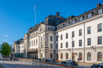 Stockholm Central Station showcases its impressive architecture under a bright blue sky. People can...