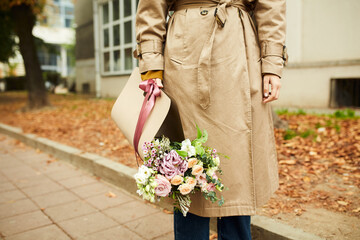 Woman carrying flowers on the street