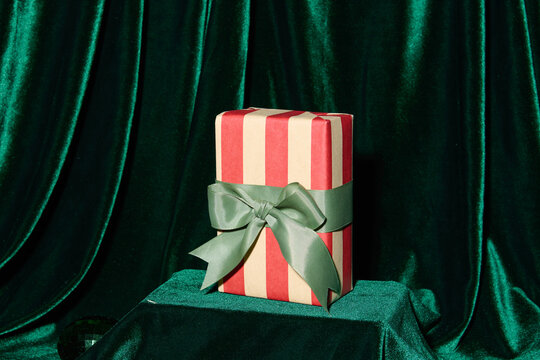 Elegant Gift Box with Green Ribbon on Velvet Background