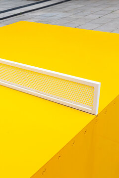 Close-up of modern minimal colourful yellow sport ping pong table 
