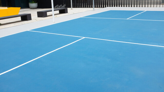 Modern minimal simple blue tennis field in a urban city environment