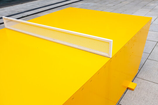 Close-up of modern minimal colourful yellow sport ping pong table 